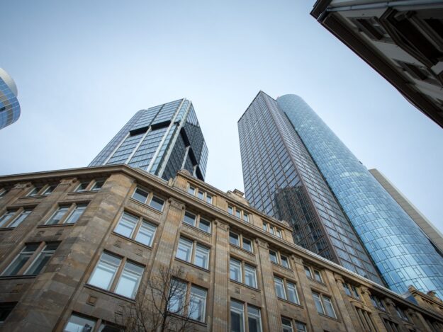 Low angle shot of high rise skyscrapers under the clear sky in Frankfurt, Germany A low angle shot of high rise skyscrapers under the clear sky in Frankfurt, Germany